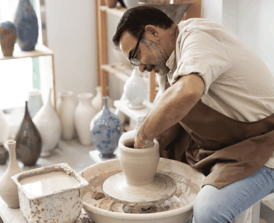 this image maybe contain a man working with clay